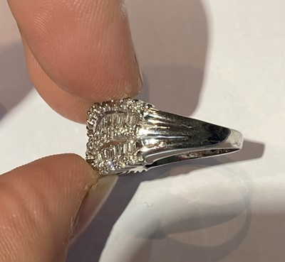Lot 81 - A diamond two row twist ring, stamped '14K',...