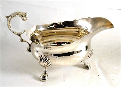 Lot 333 - A silver sauce boat on three hoof feet, London 1930