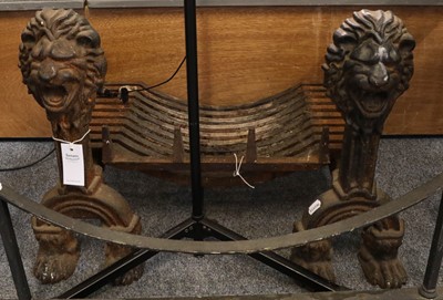 Lot 1409 - A pair of cast iron lion mask fire andirons,...