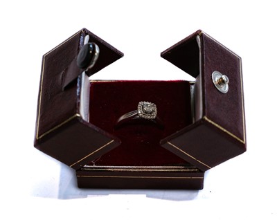 Lot 145 - An 18 carat white gold diamond cluster ring,...