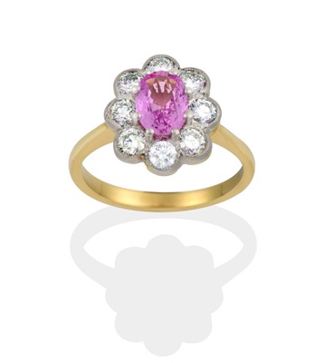 Lot 2389 - A Pink Sapphire and Diamond Cluster Ring