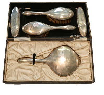 Lot 304 - A five-piece George V cased silver dressing...