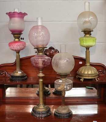 Lot 361 - ~  Four Victorian brass based oil lamps...