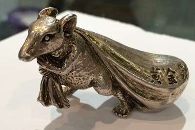 Lot 271 - A Japanese white metal model of a rat carrying...