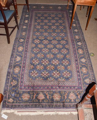 Lot 1223 - A Balouch rug, the indigo field of stylised...