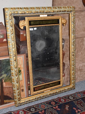 Lot 1371 - A gilt framed mirror mounted with rams heads...