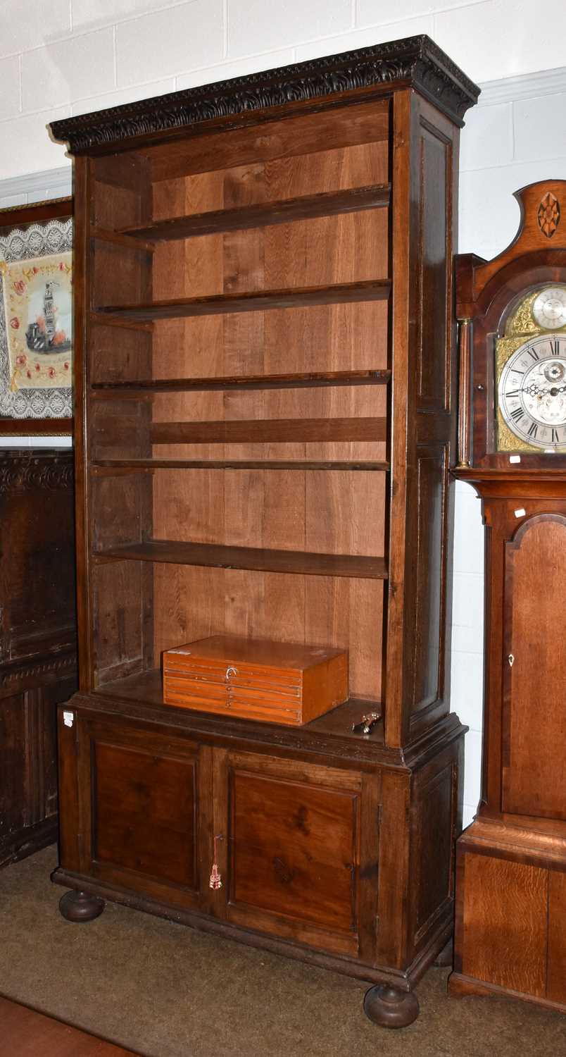 Lot 1366 - An 18th century style oak open bookcase, the...