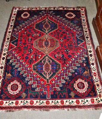 Lot 423 - A Persian Quashqi tribal rug, the lozenge field with three step medallions, 160 by 121cm