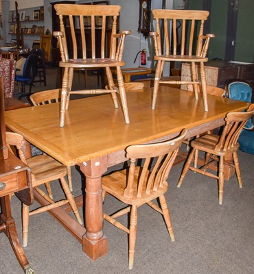 Lot 1319 - A large oak table and eight pine chairs, 212cm...