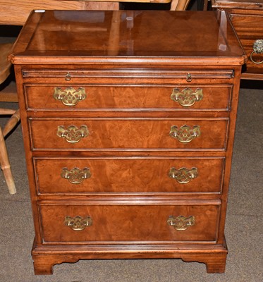 Lot 1250 - A reproduction walnut veneered bachelors chest...