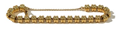 Lot 283 - A fancy link bracelet, stamped '18KT', length...