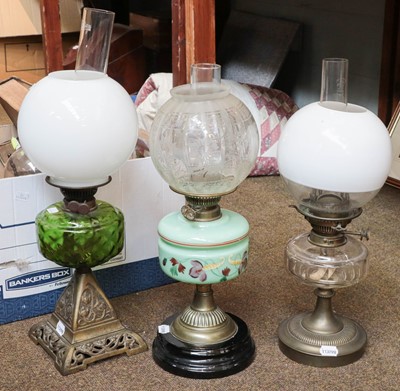 Lot 471 - Three early 20th century oil lamp with glass...