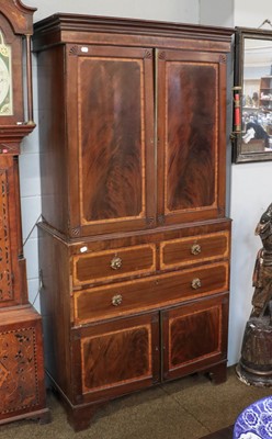 Lot 1241 - A early 19th century mahogany linen press, the...