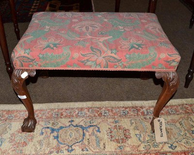 Lot 463 - An upholstered dressing stool with shell capped cabriole legs and ball and claw feet