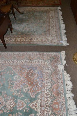 Lot 470 - Carpet of Oriental design, the mint field with an all over floral design enclosed by ivory borders