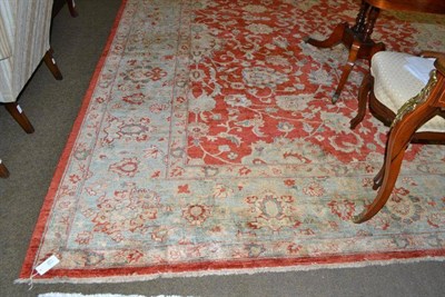 Lot 471 - Afghan 'Ziegler' design carpet, the blood red field of scrolling vines enclosed by ice blue...