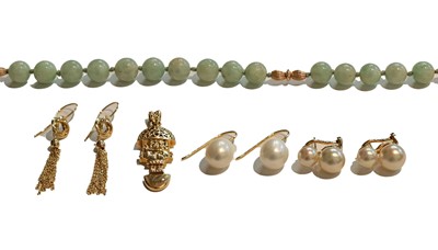 Lot 259 - A jade bead necklace, clasp stamped '14K585',...