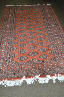 Lot 474 - Bokhara rug, Lahore, the rust field with columns of salor guls enclosed by sunburst borders, 256 by