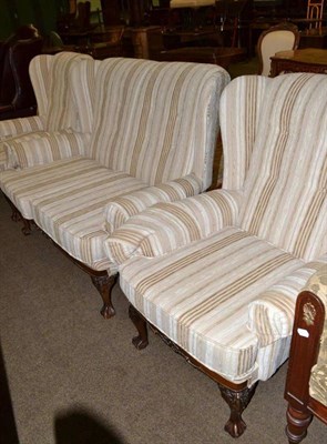 Lot 484 - A 1920's/30's three piece suite on claw and ball feet, re-covered in cream striped fabric