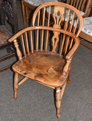 Lot 1310 - A 19th century ash and elm windsor armchair,...