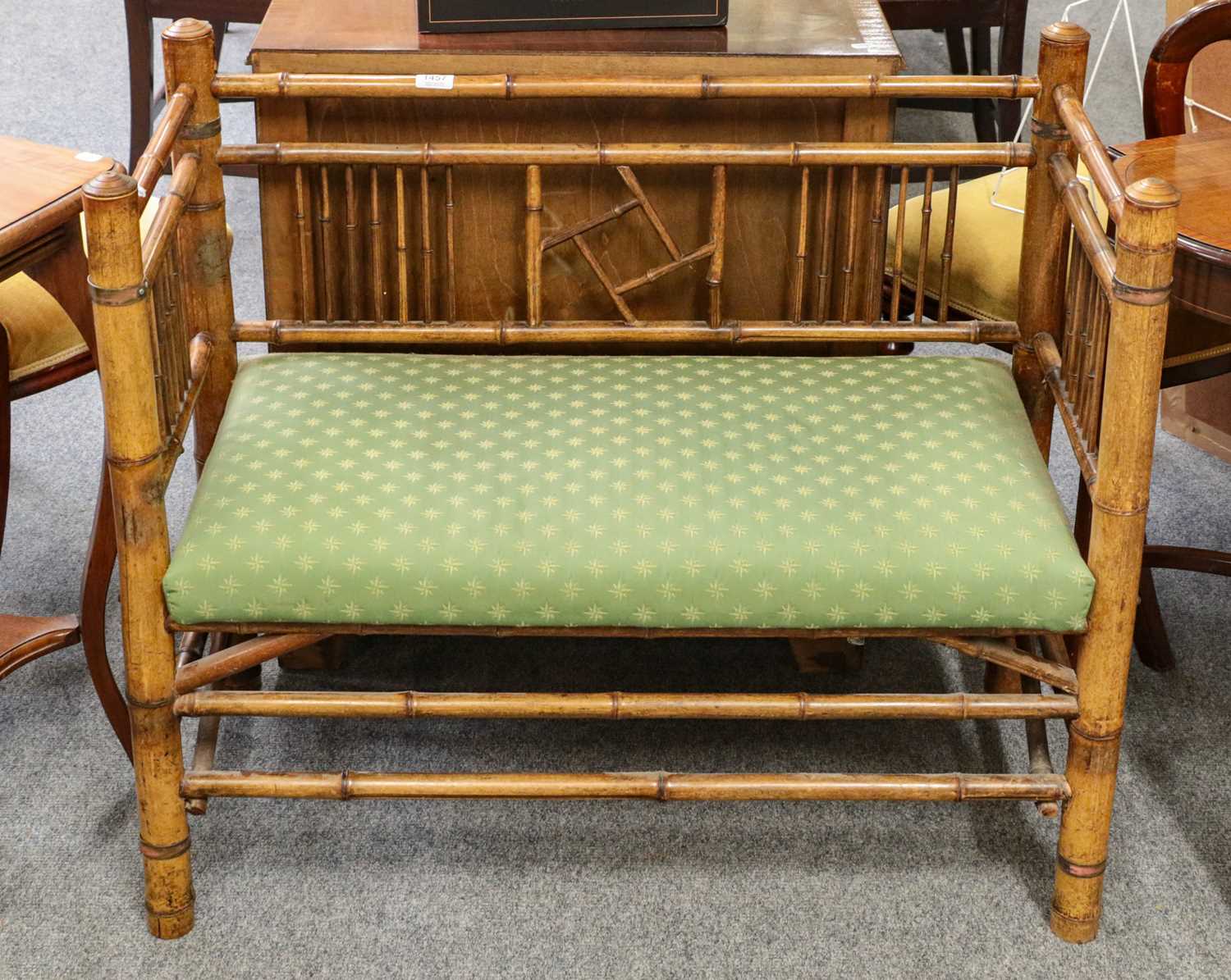 Lot 1457 - ~ A bamboo simulated bedroom sofa upholstered...