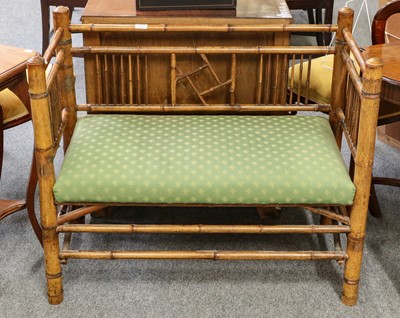 Lot 1457 - ~  A bamboo simulated bedroom sofa upholstered...