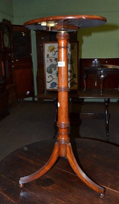 Lot 520 - A mahogany tripod table with turned support, flip top and adjustable height