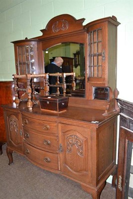 Lot 544 - An Art Nouveau carved oak mirror back sideboard