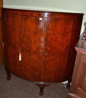 Lot 547 - A walnut D-shaped cabinet