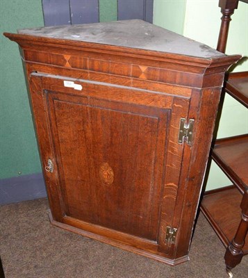 Lot 553 - An 18th century oak hanging corner cupboard