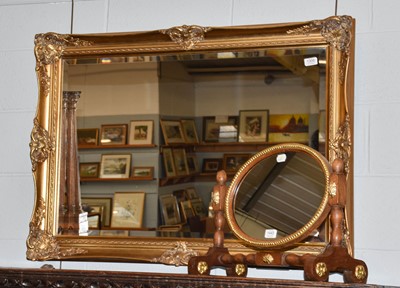 Lot 1306 - A reproduction gilt bevel glass mirror, 76cm...