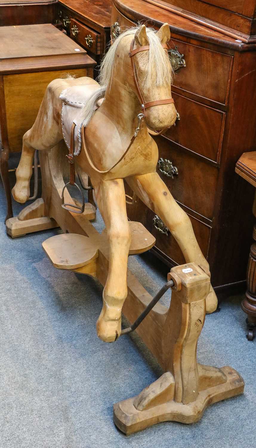 Lot 1206 A handcarved rocking horse on trestle base,
