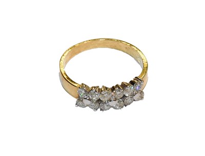 Lot 260 - An 18 carat gold diamond cluster ring, finger...