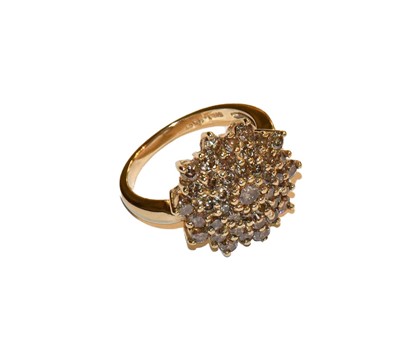 Lot 288 - A fancy coloured diamond cluster ring, stamped...