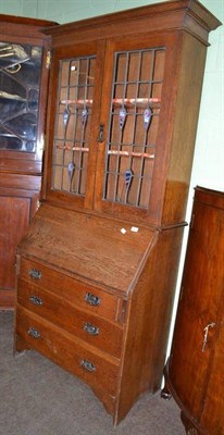 Lot 567 - Oak bureau bookcase with leaded glass doors