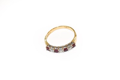 Lot 199 - An 18 carat gold ruby and diamond ring, finger...