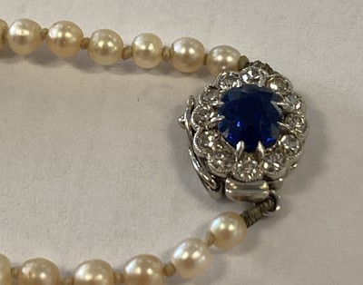 Lot 2000 - A Pearl Necklace, with a Sapphire and Diamond Cluster Clasp