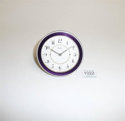 Lot 1022 - A Enamel Strut Timepiece, purple coloured enamel bezel, sides with white enamel border, ivorine...