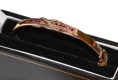 Lot 185 - A synthetic ruby and diamond hinged bangle,...