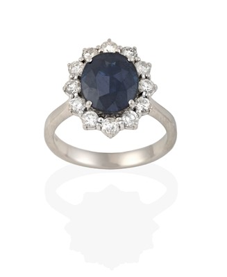 Lot 2392 - A Sapphire and Diamond Cluster Ring