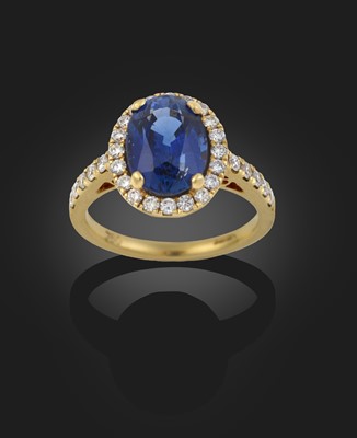 Lot 2084 - An 18 Carat Gold Sapphire and Diamond Cluster Ring