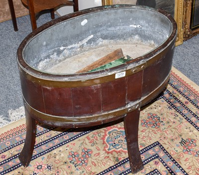 Lot 1270 - A coopered mahogany planter of oval form, 64cm...