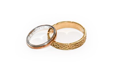 Lot 174 - An 18 carat gold textured band ring, finger...