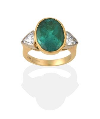 Lot 2032 - An Emerald and Diamond Three Stone Ring
