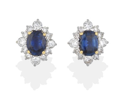 Lot 2053 - A Pair of 18 Carat Gold Sapphire and Diamond Cluster Earrings