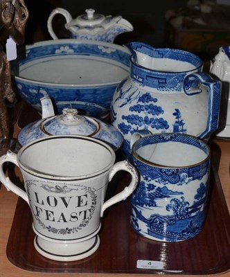 Lot 4 - A 19th century pearlware jug and a similar mug, blue and white teapot and a loving cup 'Love Feast'