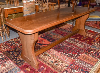 Lot 1211 - An oak refectory table with a trestle base and...