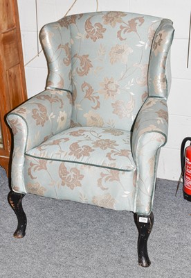 Lot 1295 - An early 20th century wing chair upholstered...