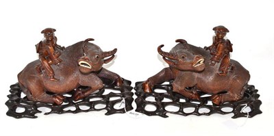 Lot 41 - A pair of late 19th century Japanese carved buffalo on stands
