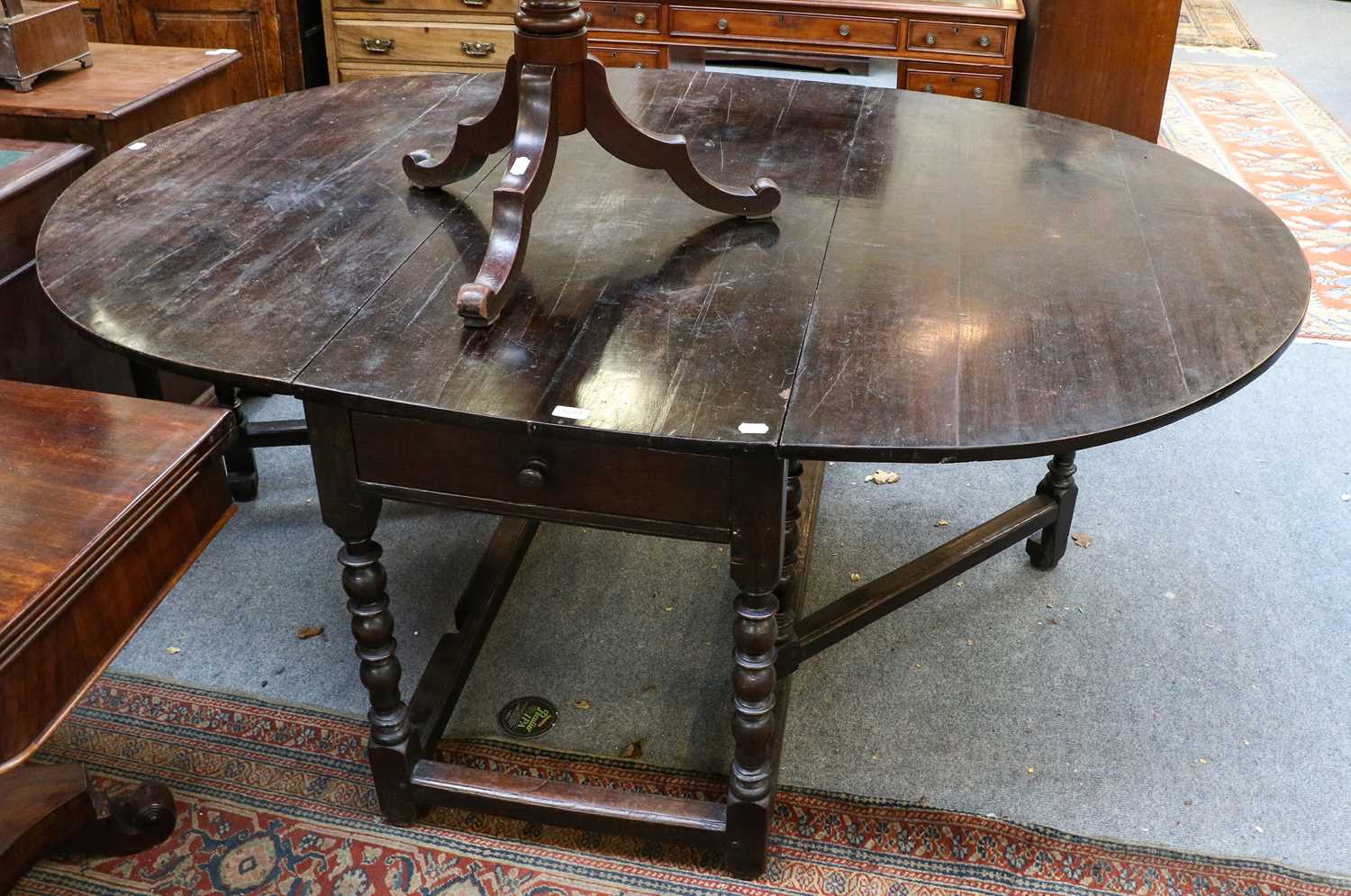 Lot 1234 - An 18th century oak gateleg dining table,...